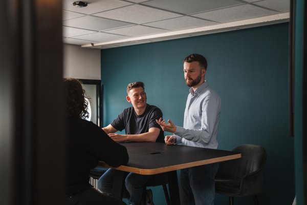 Team van Prikr bespreekt de webapplicatie-roadmap met KPI-dashboard op scherm